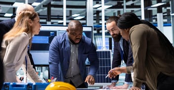 Manufacturing team analyzing system data and workflows, highlighting ERP complexity in manufacturing and its impact on performance and coordination