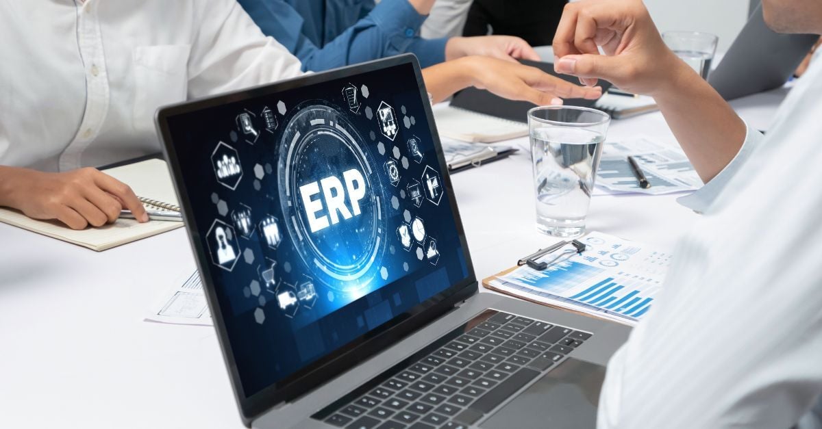 Team reviewing ERP dashboards and operational reports during cloud ERP governance and business planning meeting.