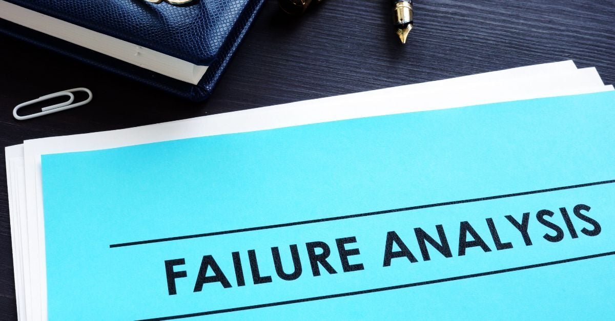 Failure analysis report on office desk with business documents, pen, and glasses for risk assessment review
