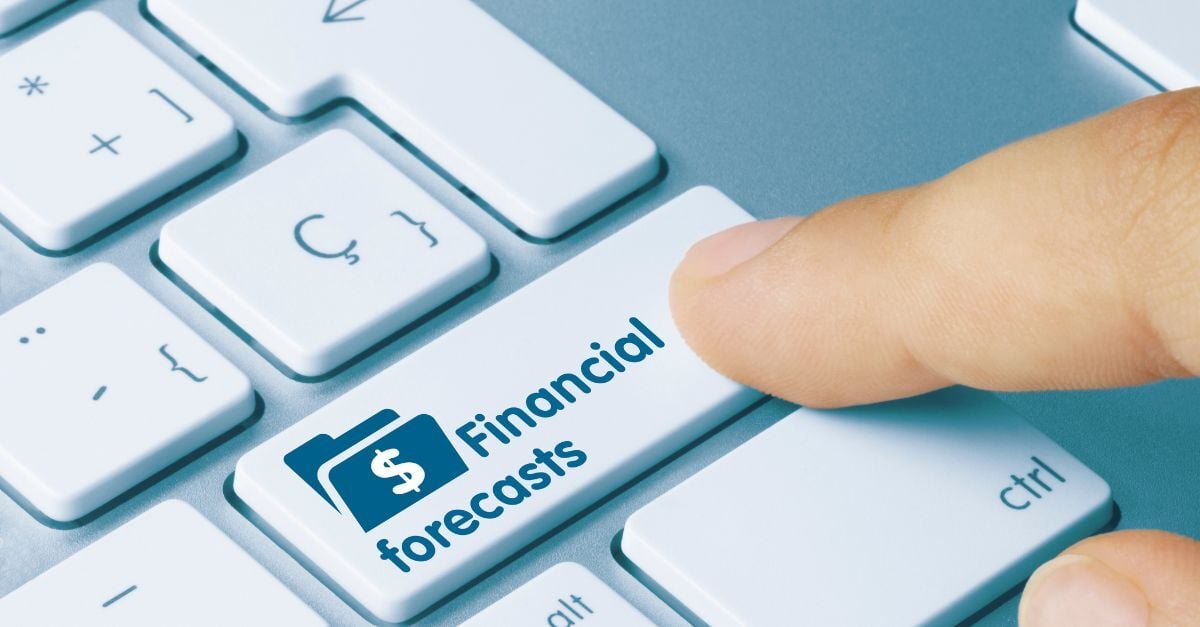 Finger pressing financial forecasts key on computer keyboard, representing budgeting and business planning analytics