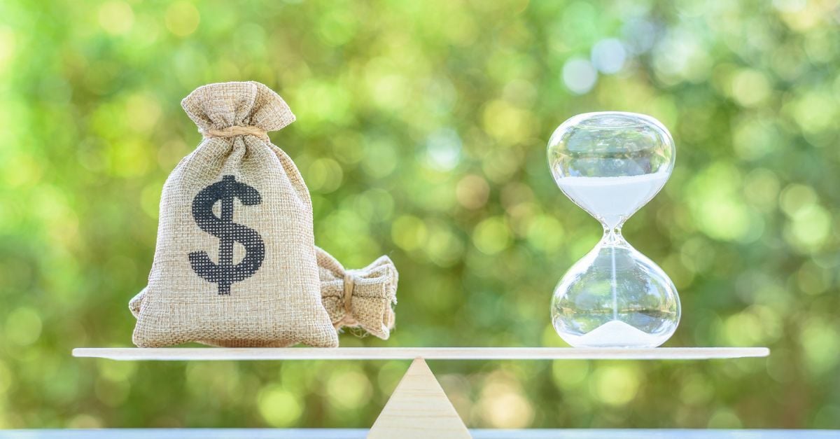 ERP Implementation Cost Over Time represented by a money bag and hourglass balanced on a scale.