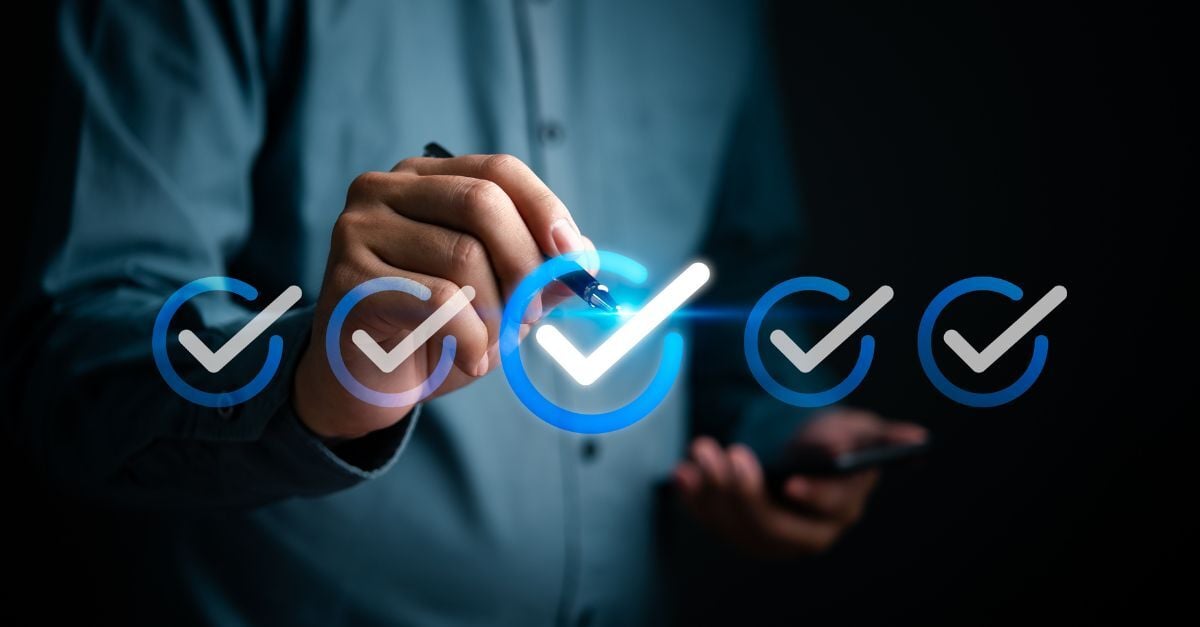 Person marking digital checkmarks, representing completed steps in an ERP migration checklist.