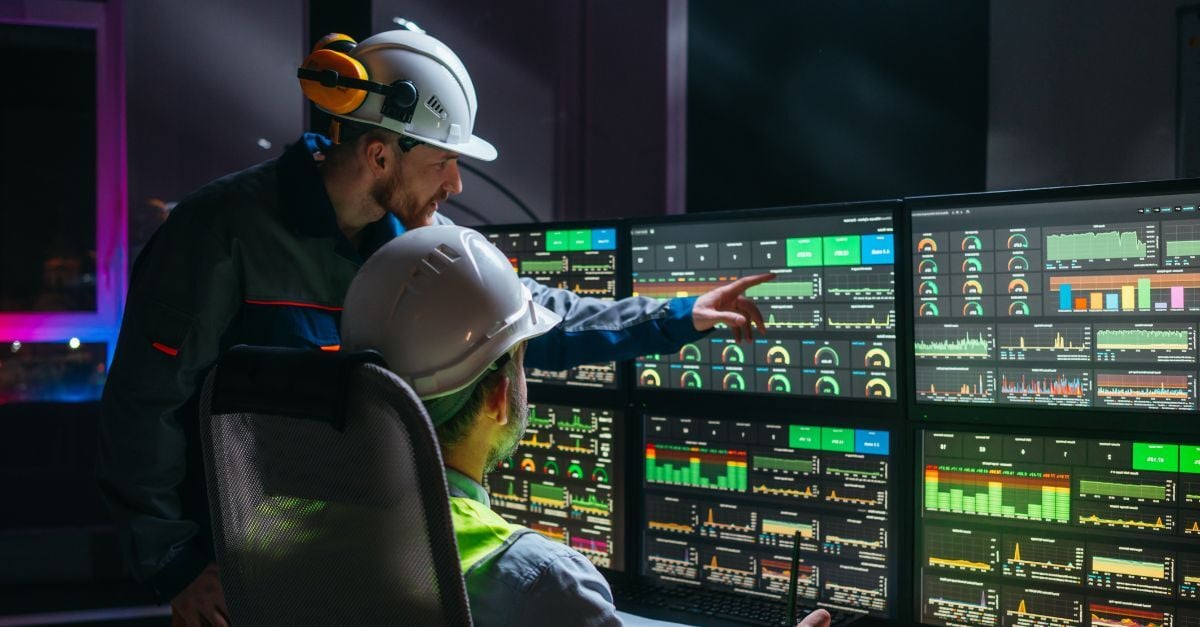 Engineers monitor production dashboards, supporting ERP stability in manufacturing and plant performance.