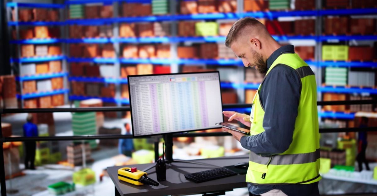 Warehouse employee using ERP system for inventory and production tracking, representing an Epicor alternative for small manufacturers like SAP Business One