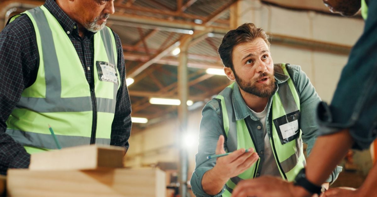 Warehouse supervisors reviewing production workflow, illustrating operational control in manufacturing ERP