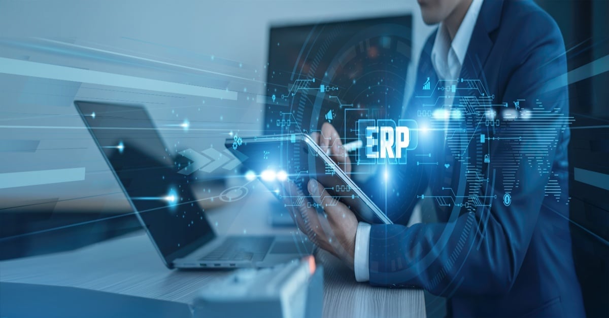 Business professional using a tablet and laptop with a digital ERP interface overlay, representing SAP Business One implementation, system integration, and modern ERP deployment for growing businesses.