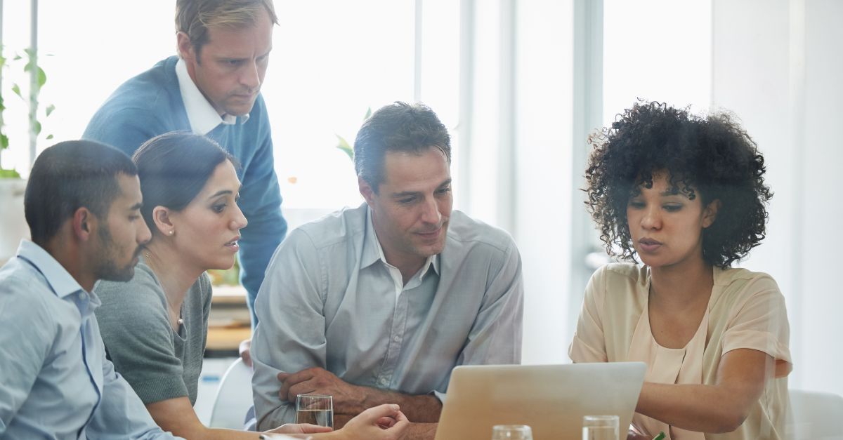 Why ERP implementations fail: project team reviews ERP strategy together during a collaborative office meeting.